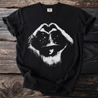 Black t-shirt with white distressed graphic of a person in a hat making a heart symbol with stars.
