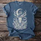 Blue t-shirt with cream occult-themed print featuring a raven, deer skull, moon, and flora.