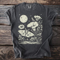 Moth and moon graphic on dark grey t-shirt with botanical details and stars.