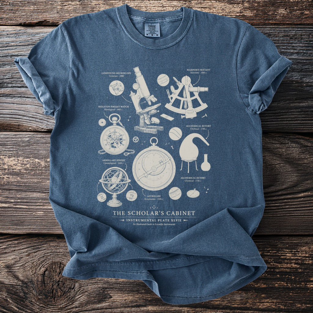 Blue t-shirt with scientific instruments illustration titled "The Scholar's Cabinet".