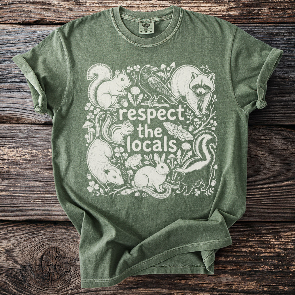 Green t-shirt with white illustration of various local animals and the text "respect the locals".
