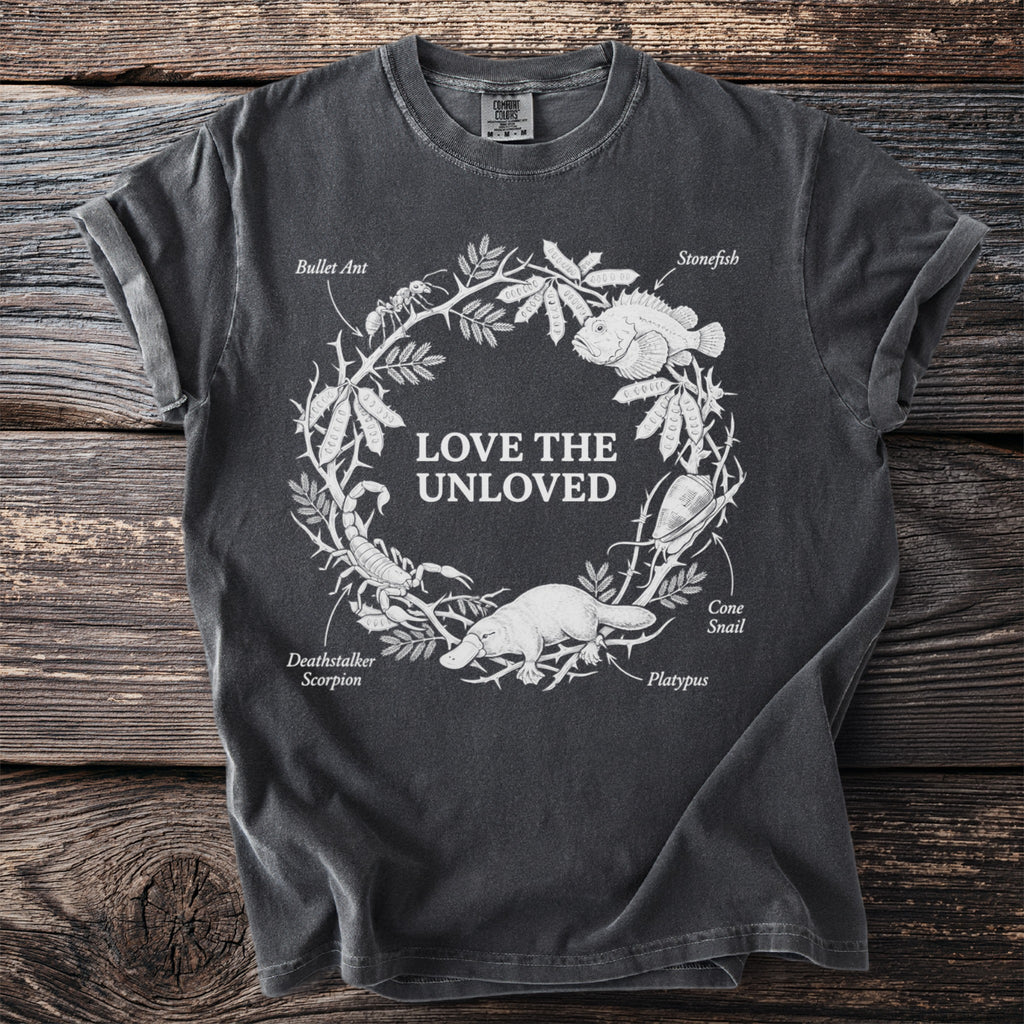 Dark grey t-shirt with "Love the Unloved" and detailed illustrations of venomous creatures.