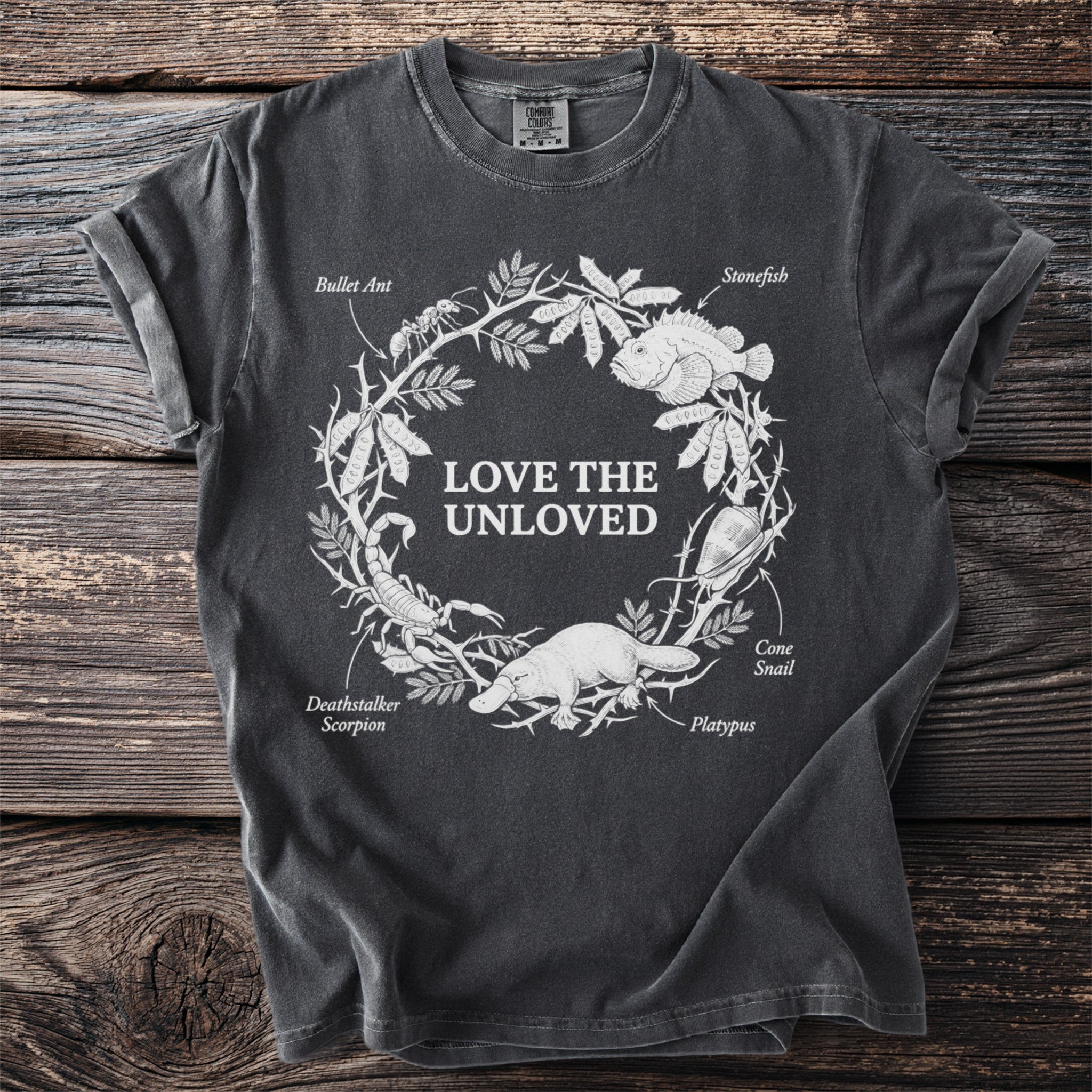 Dark grey t-shirt with "Love the Unloved" and detailed illustrations of venomous creatures.