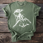 Green t-shirt with white abstract graphic of creature and heart-shaped hands holding a lighthouse.