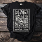 Black t-shirt with white illustration of skull, bones, plants, and mushrooms with text.