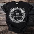 Black t-shirt with white line art of birds and text "LOVE THE UNLOVED"