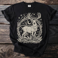 Black t-shirt with a stylized deer graphic among branches, stars, and mushrooms.