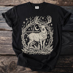 Black t-shirt with a stylized deer graphic among branches, stars, and mushrooms.