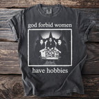 T-shirt with "God forbid women have hobbies" text and image of three witches.