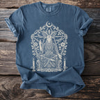 Blue t-shirt with a white occult goat, moon, and floral design.
