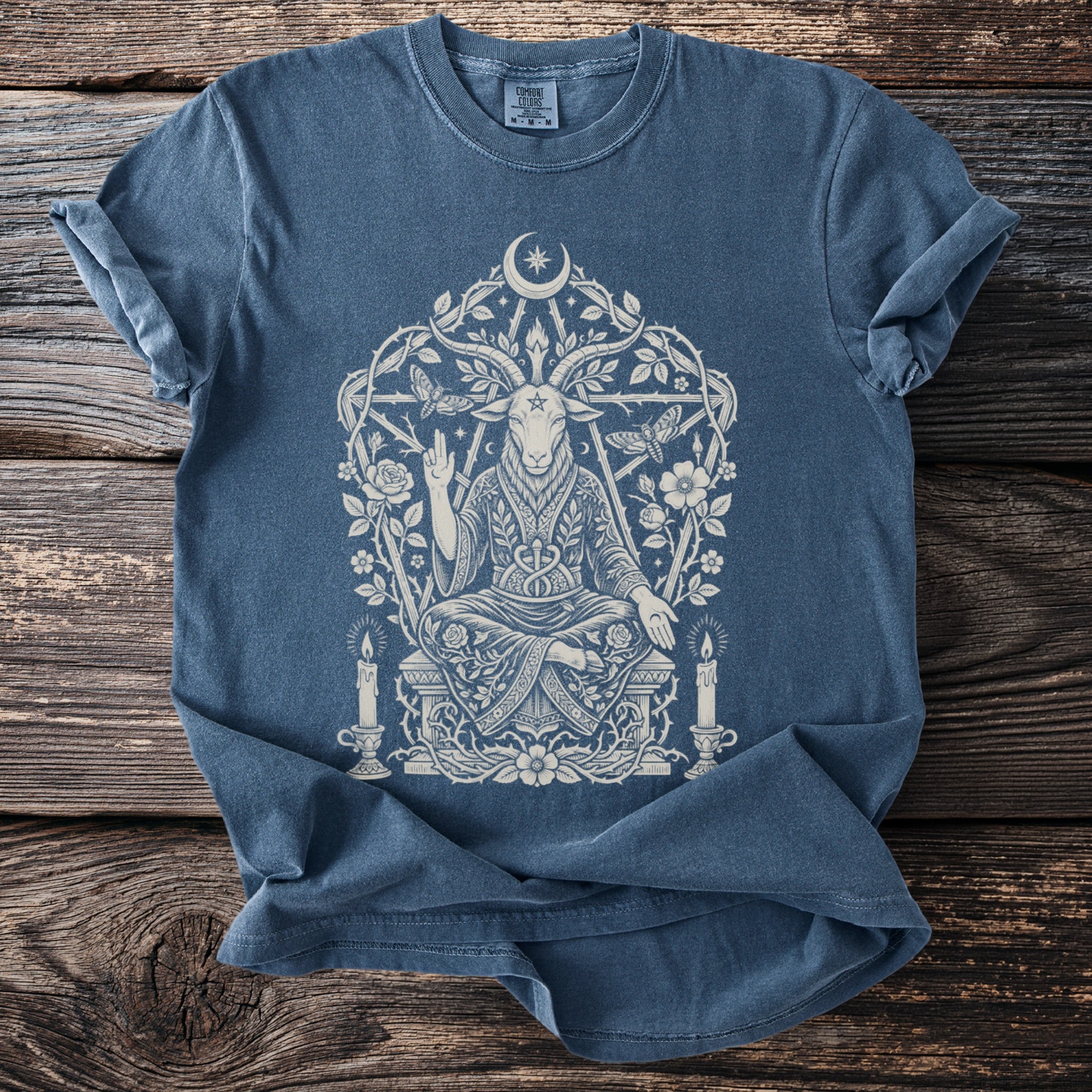 Blue t-shirt with a white occult goat, moon, and floral design.