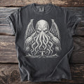 Dark t-shirt with a white graphic of a tentacled creature and a lighthouse.