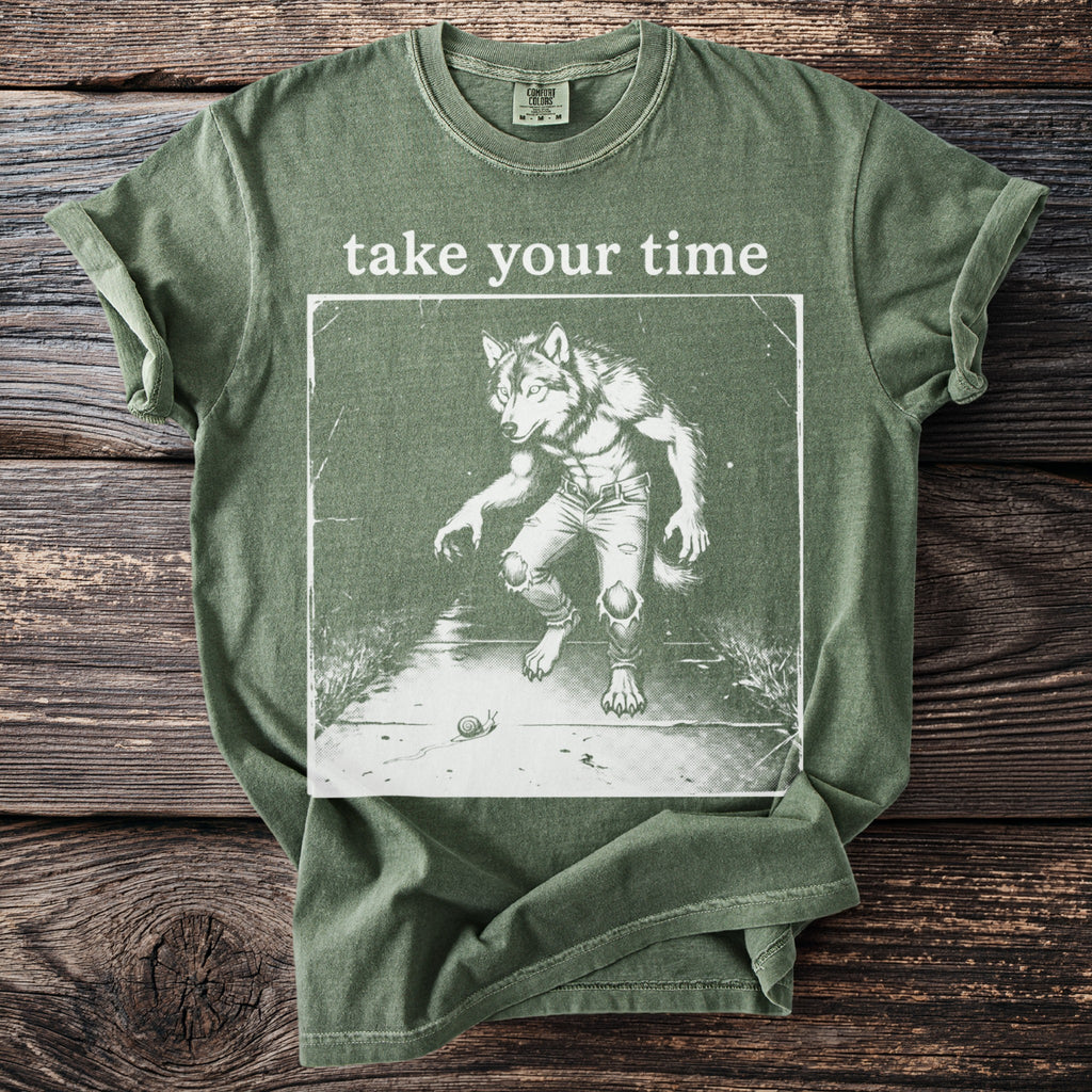 Green t-shirt with text "take your time" and illustration of werewolf and snail.