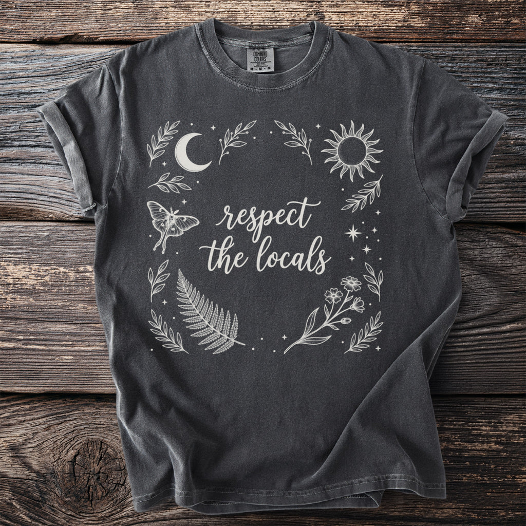 Dark grey t-shirt with "respect the locals" text and celestial nature graphics.