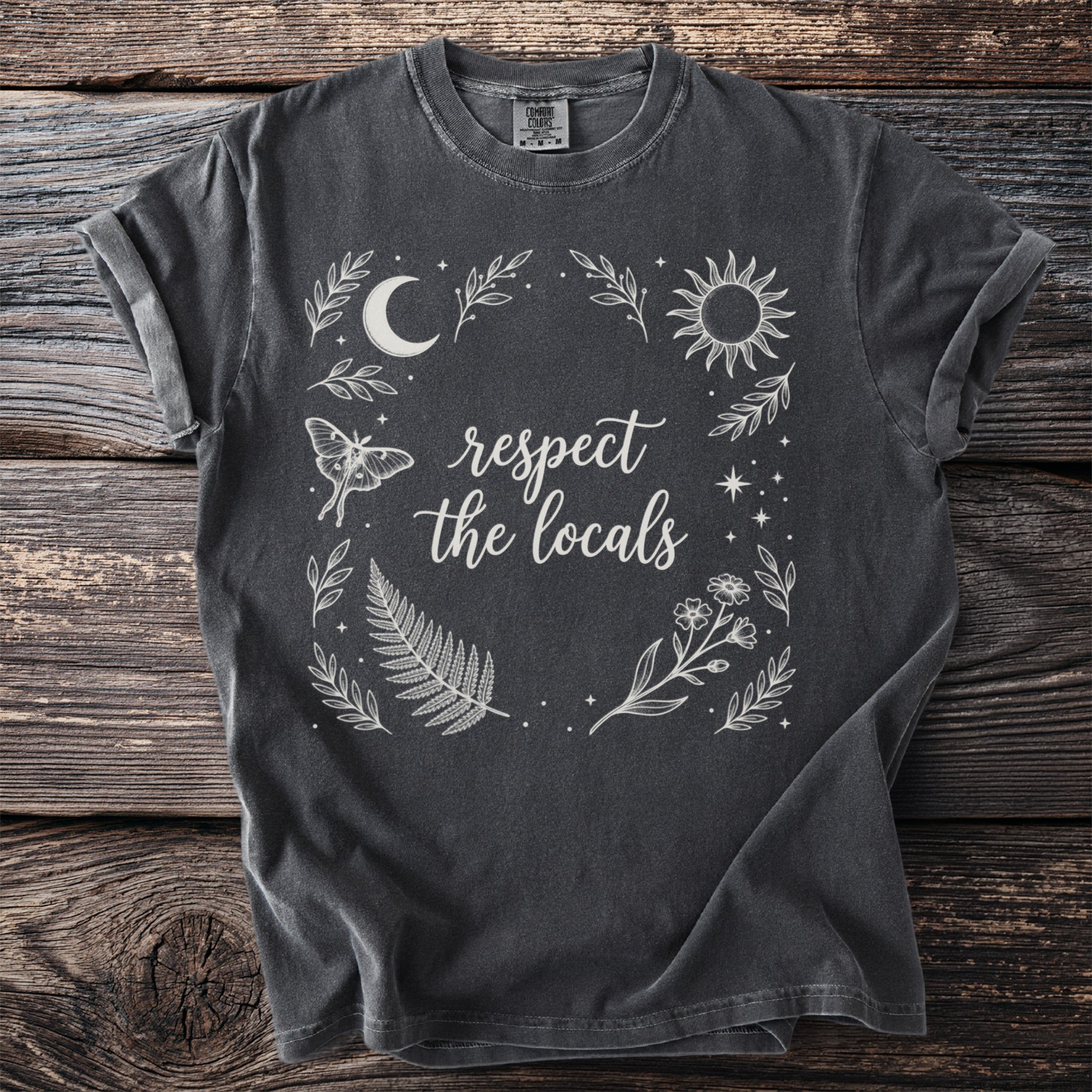 Dark grey t-shirt with "respect the locals" text and celestial nature graphics.