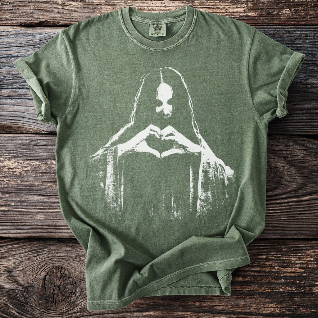 Green t-shirt with white silhouette of a person making a heart shape with hands
