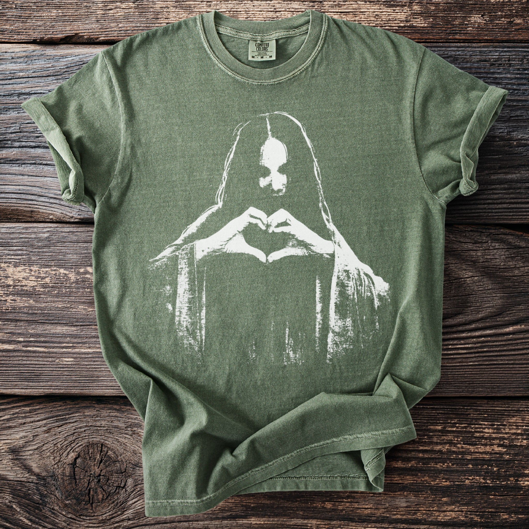 Green t-shirt with white silhouette of a person making a heart shape with hands