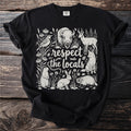 Black t-shirt with line art of diverse wildlife and text "respect the locals".