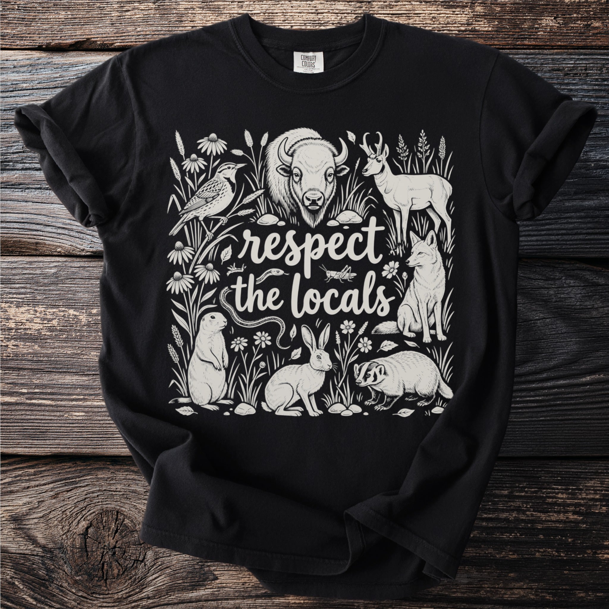 Black t-shirt with line art of diverse wildlife and text "respect the locals".