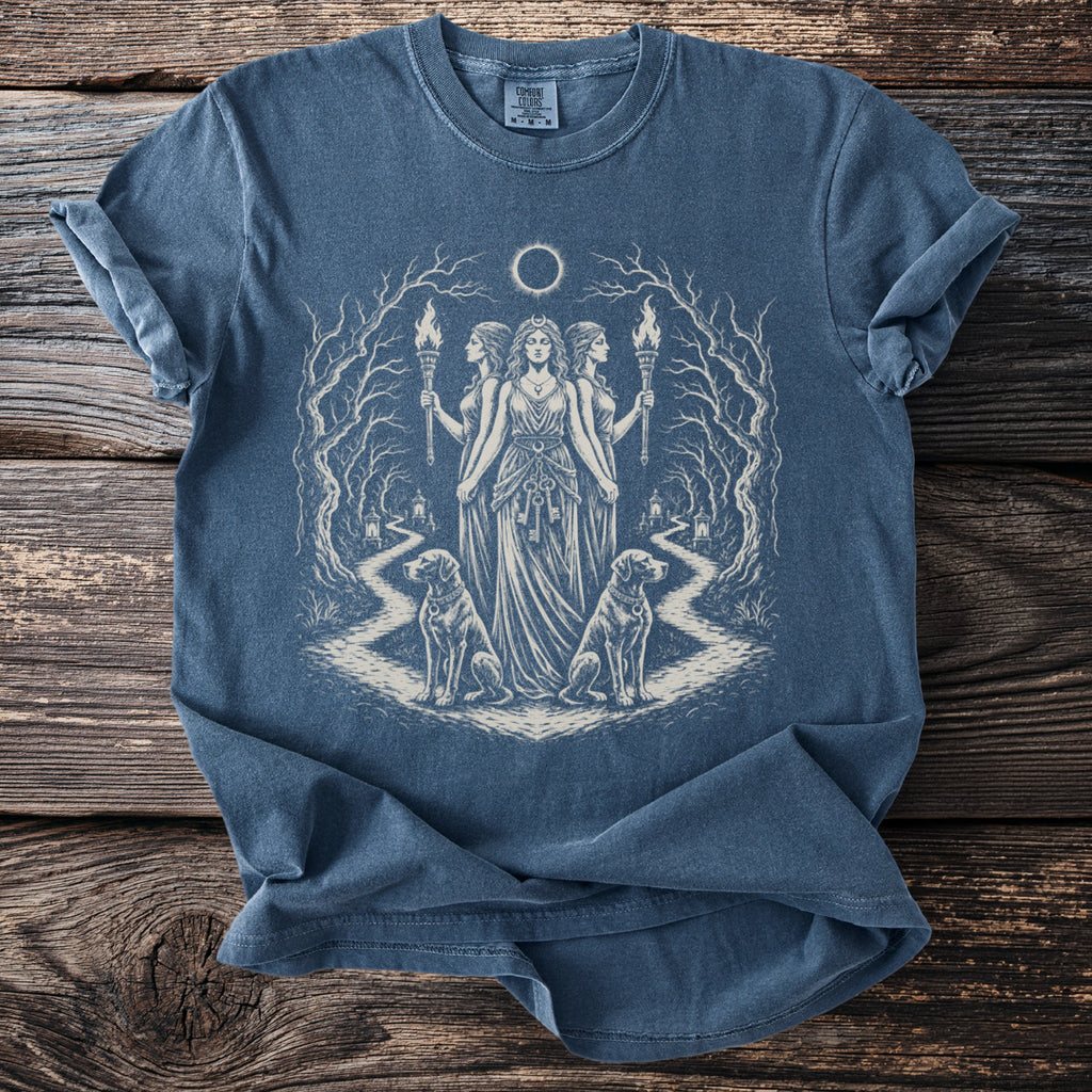 Blue t-shirt with occult artwork of three women, torches, dogs, and a moon eclipse.
