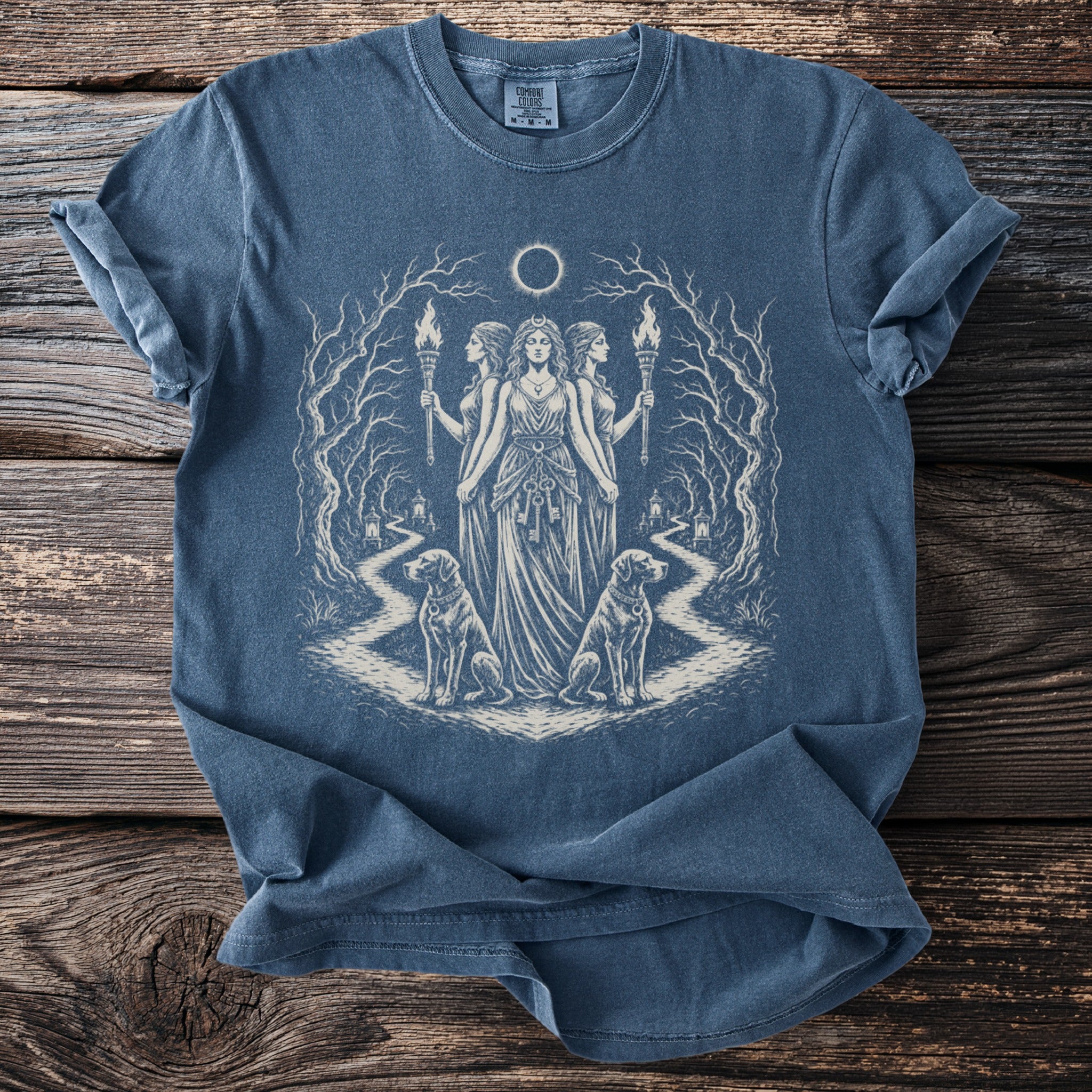 Blue t-shirt with occult artwork of three women, torches, dogs, and a moon eclipse.