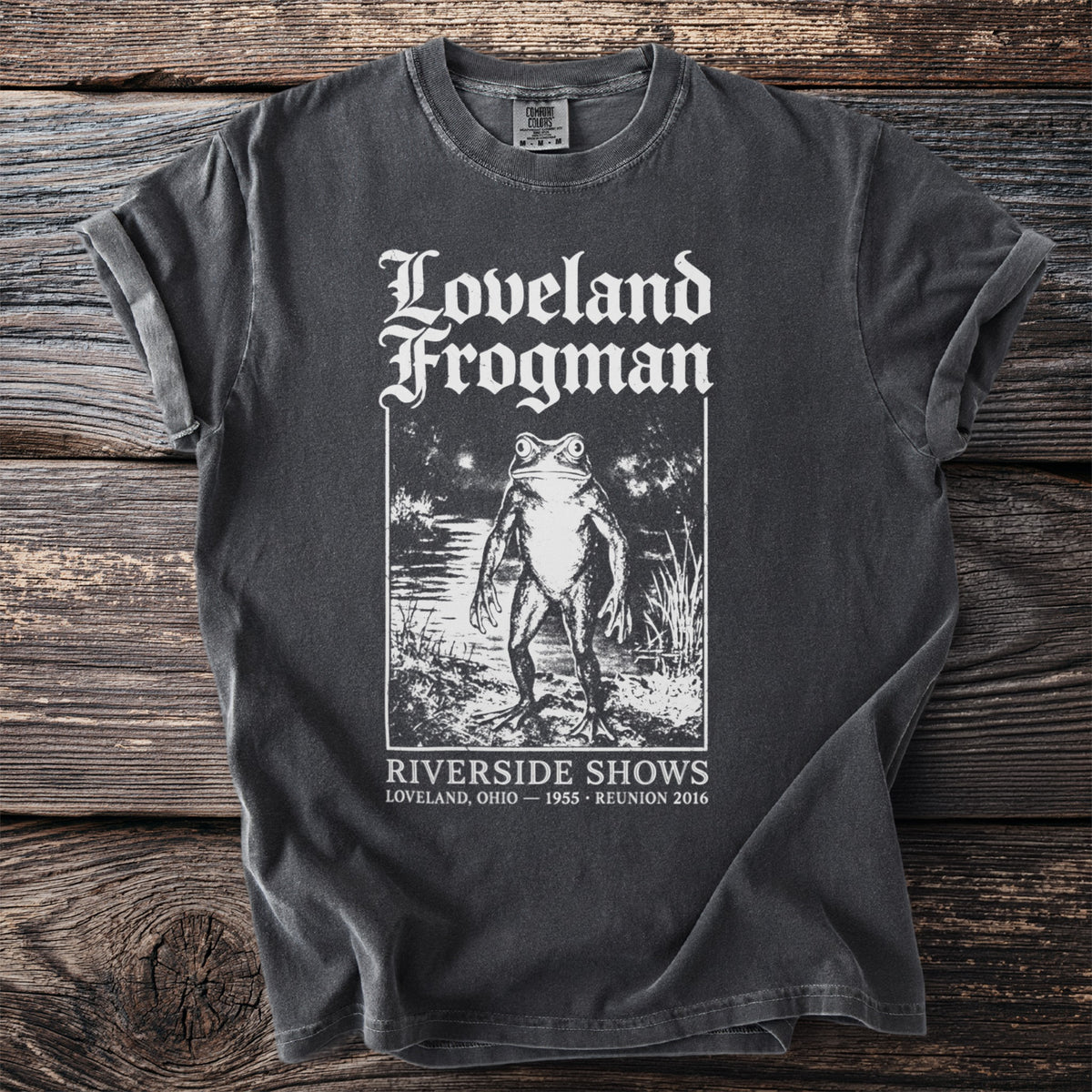 Dark gray t-shirt with Loveland Frogman graphic and text.