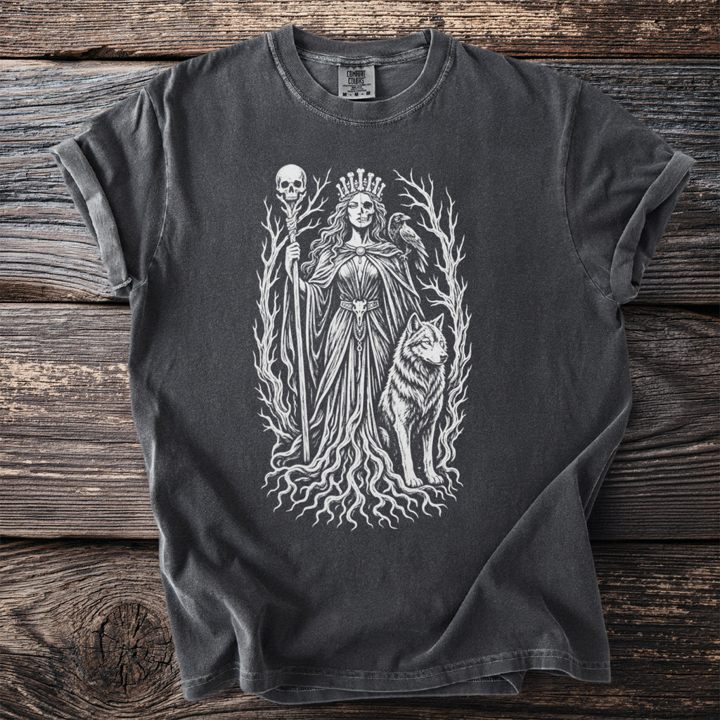 Dark t-shirt with white graphic of a crowned queen with skull features, wolf, raven, and barren trees.