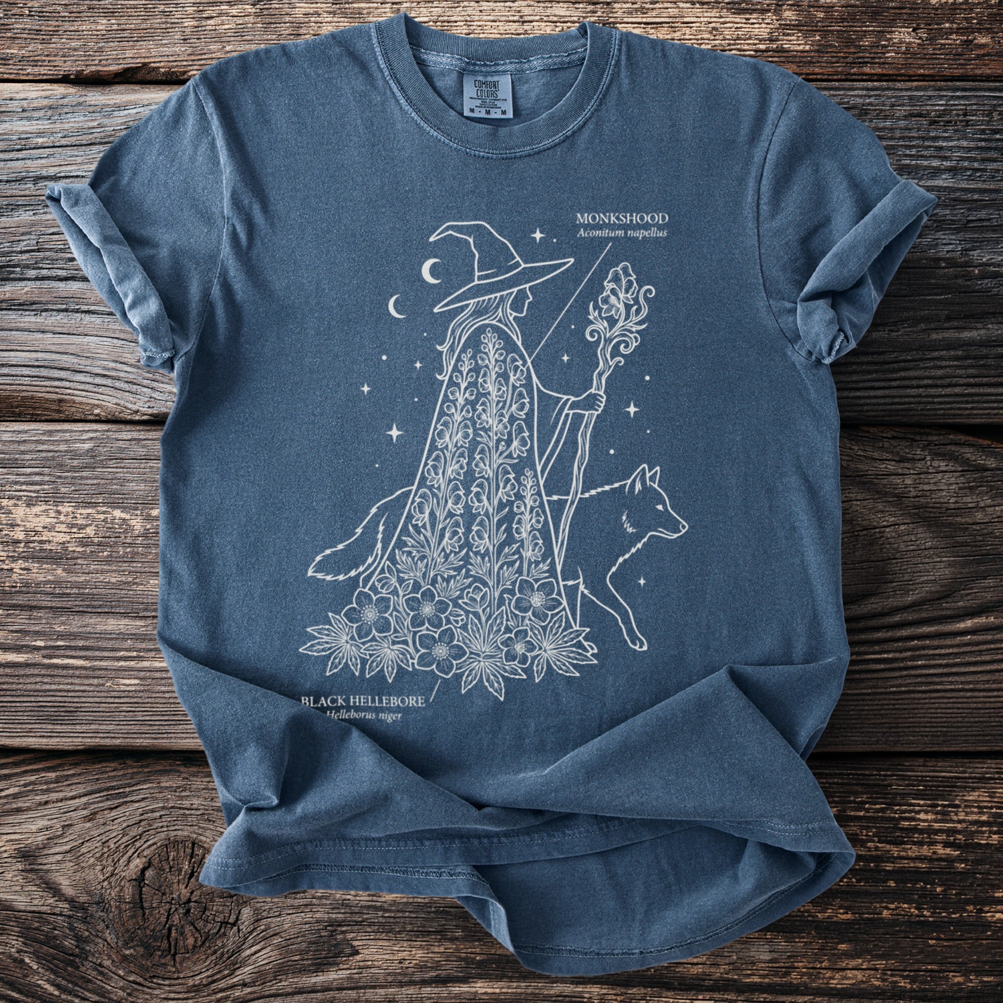 T-shirt with a white line drawing of a witch and a wolf, with "Monkshood" text.