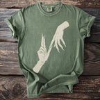 Green t-shirt with a cream graphic of two skeletal hands with long, sharp nails.