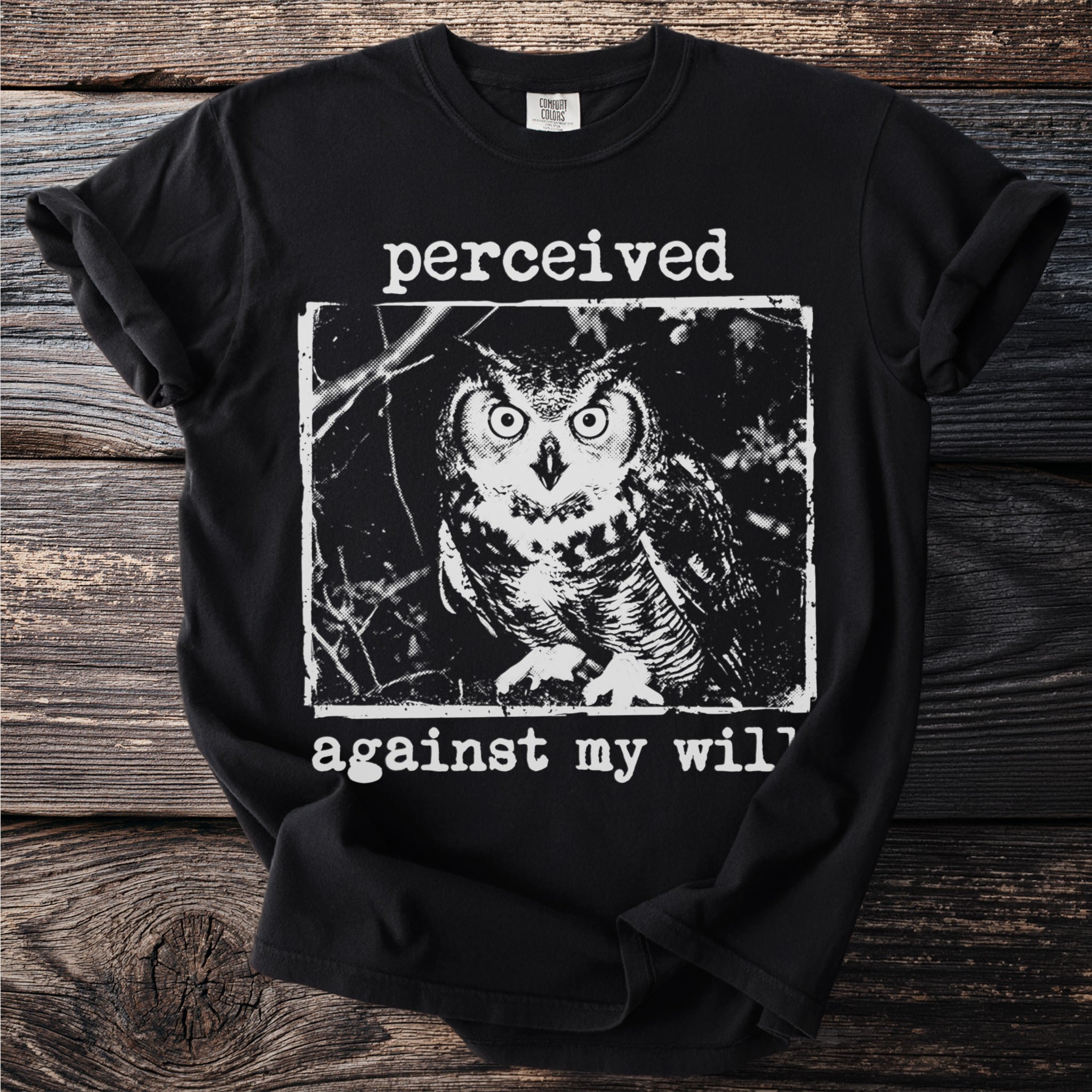 Black t-shirt with owl graphic and "perceived against my will" text.