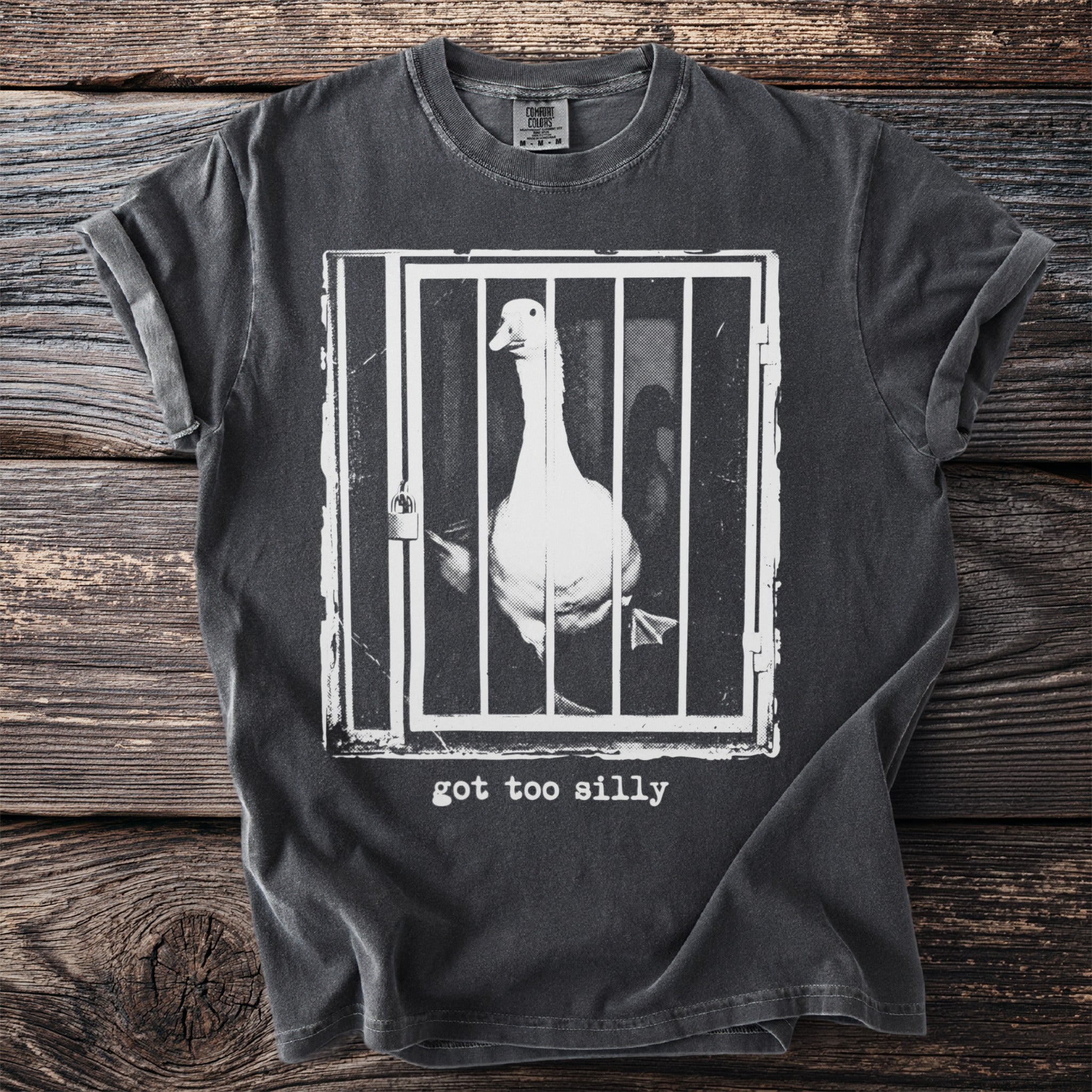 Dark gray t-shirt with a goose in a cage graphic and "got too silly" text.