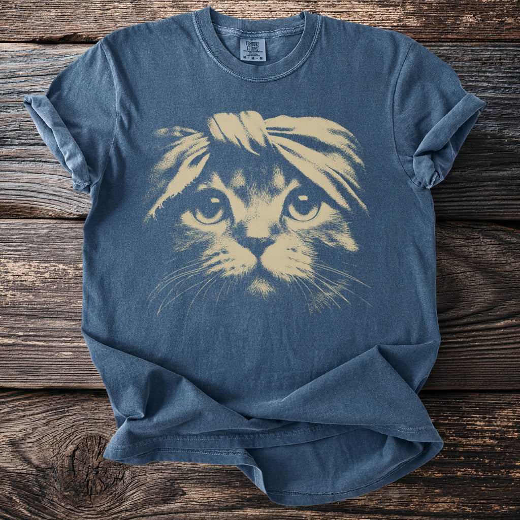 Blue t-shirt with a tan graphic of a cat wearing a headband.