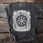 Dark t-shirt with white Viking helm, Vegvisir symbol, axes, and forest scene.