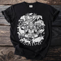 Black t-shirt with a white circular design of a seated shaman surrounded by various animals.