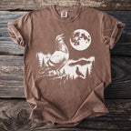 Brown t-shirt featuring a graphic of two pigeons and a moon.