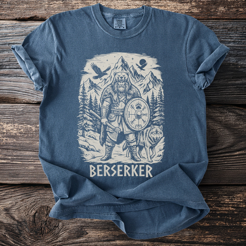 Blue t-shirt with a viking berserker, wolf, axe, shield, and mountains graphic.