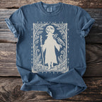 Blue t-shirt with a white print of a cloaked figure, ravens, and runes.