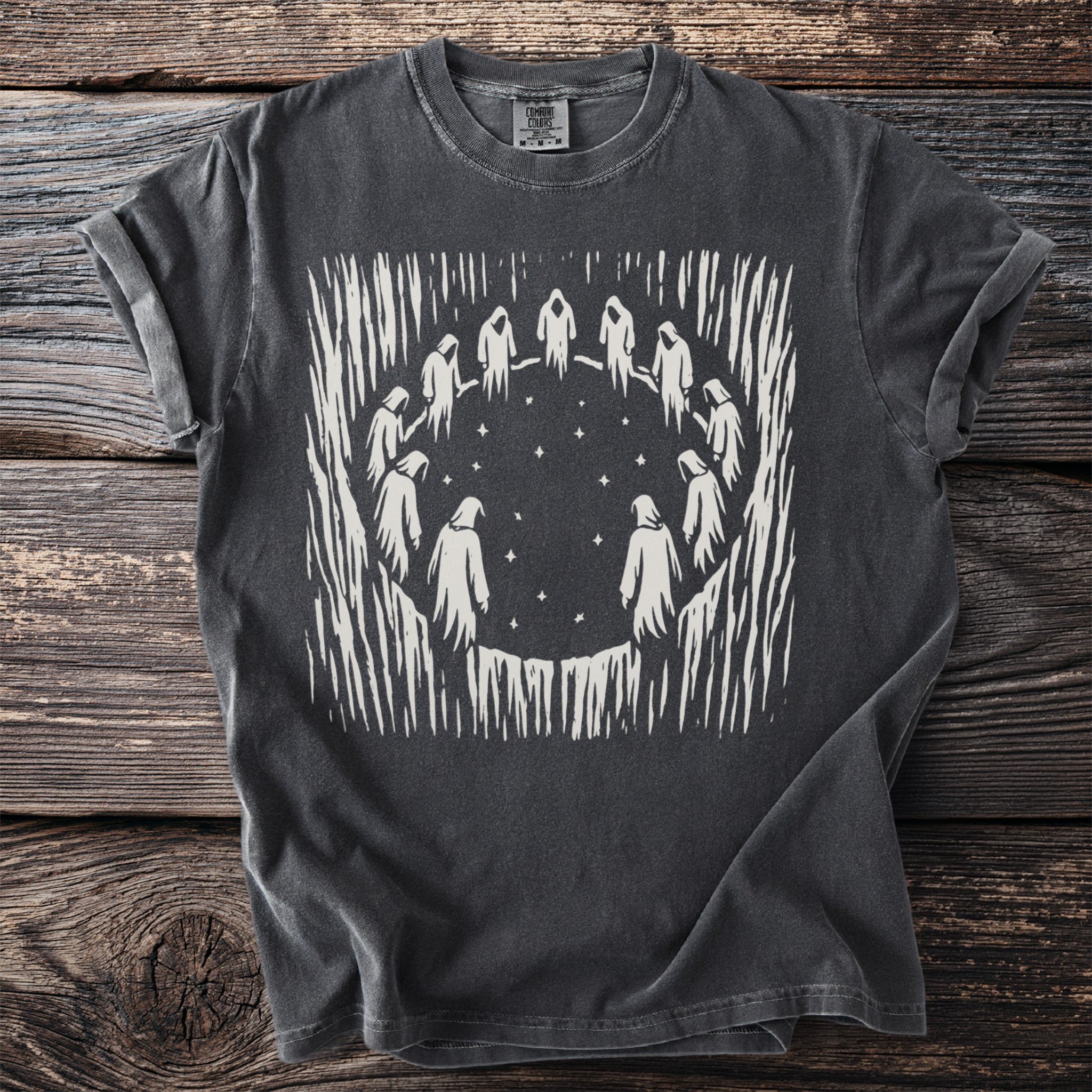 Charcoal t-shirt with a white graphic of robed figures in a circle around stars.