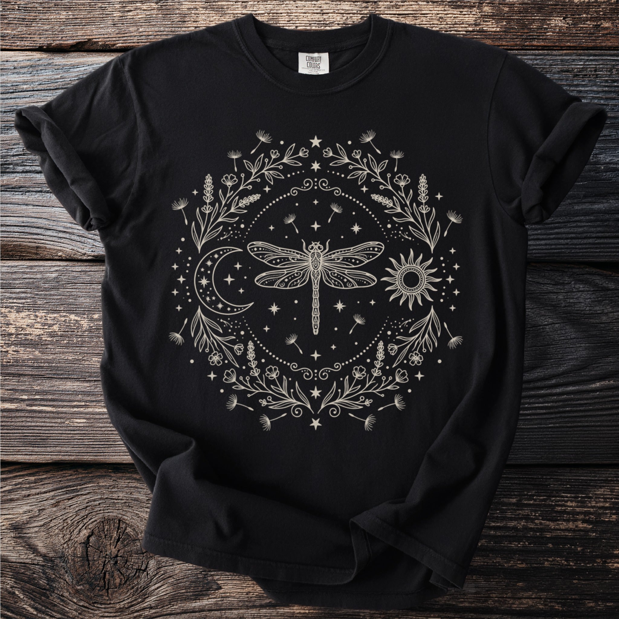 Black t-shirt with a light beige circular celestial design featuring a dragonfly, sun, and moon.
