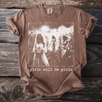 Brown t-shirt with a graphic of three women in a cornfield holding a pumpkin; text reads "girls will be girls".