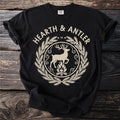 Black t-shirt with "HEARTH & ANTLER" text and deer over campfire graphic.