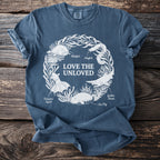 Blue t-shirt with "Love the Unloved" text and marine life illustrations.