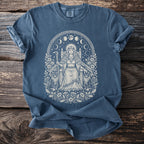 Blue t-shirt with a white graphic of a crowned woman on a throne between two cats.
