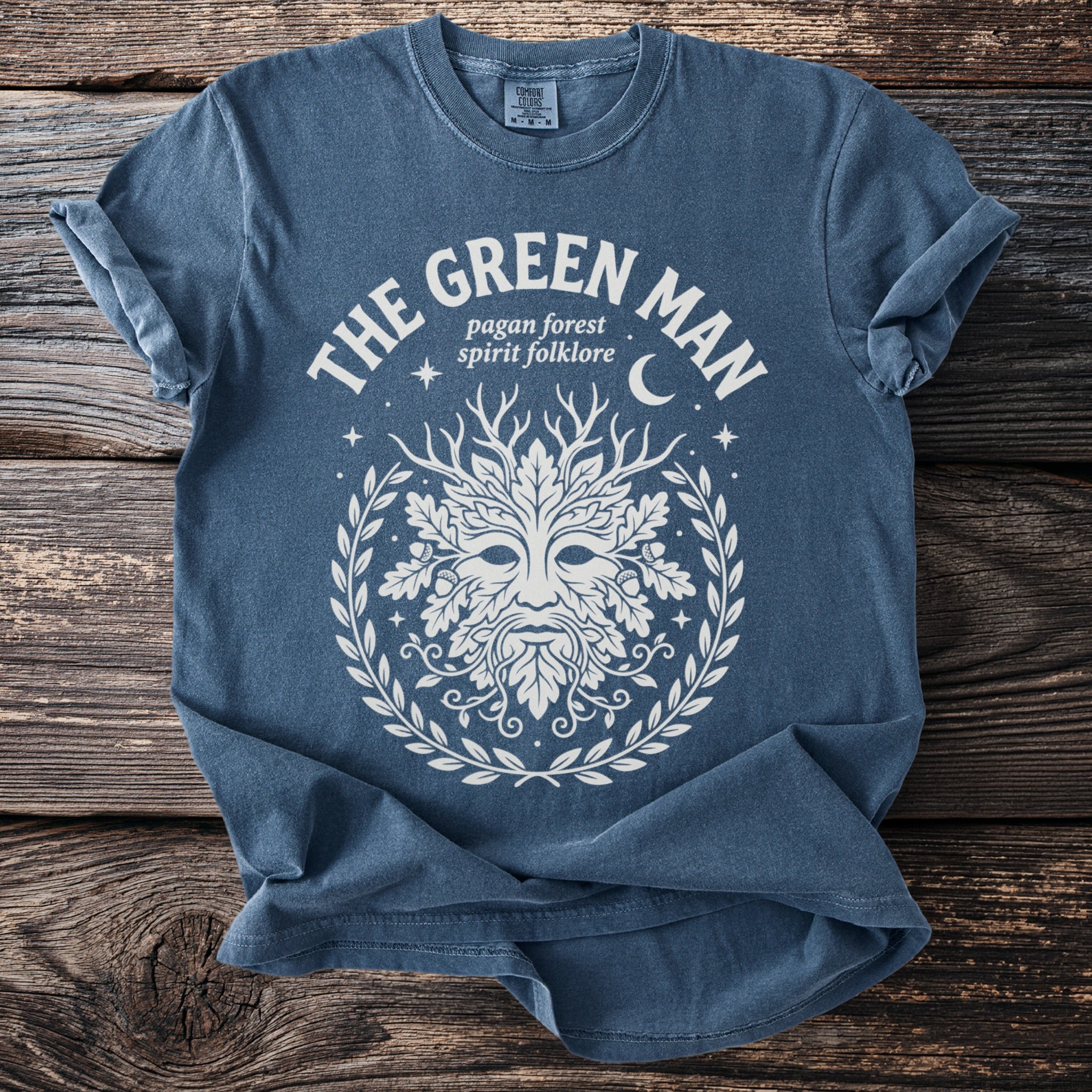 Blue t-shirt with The Green Man design and text "pagan forest spirit folklore".