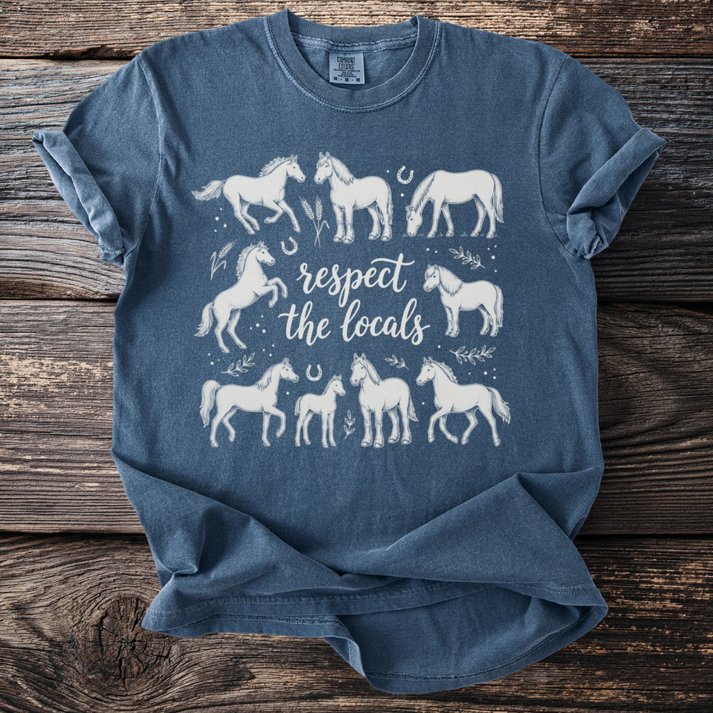 Blue t-shirt with white horse illustrations and "respect the locals" text.