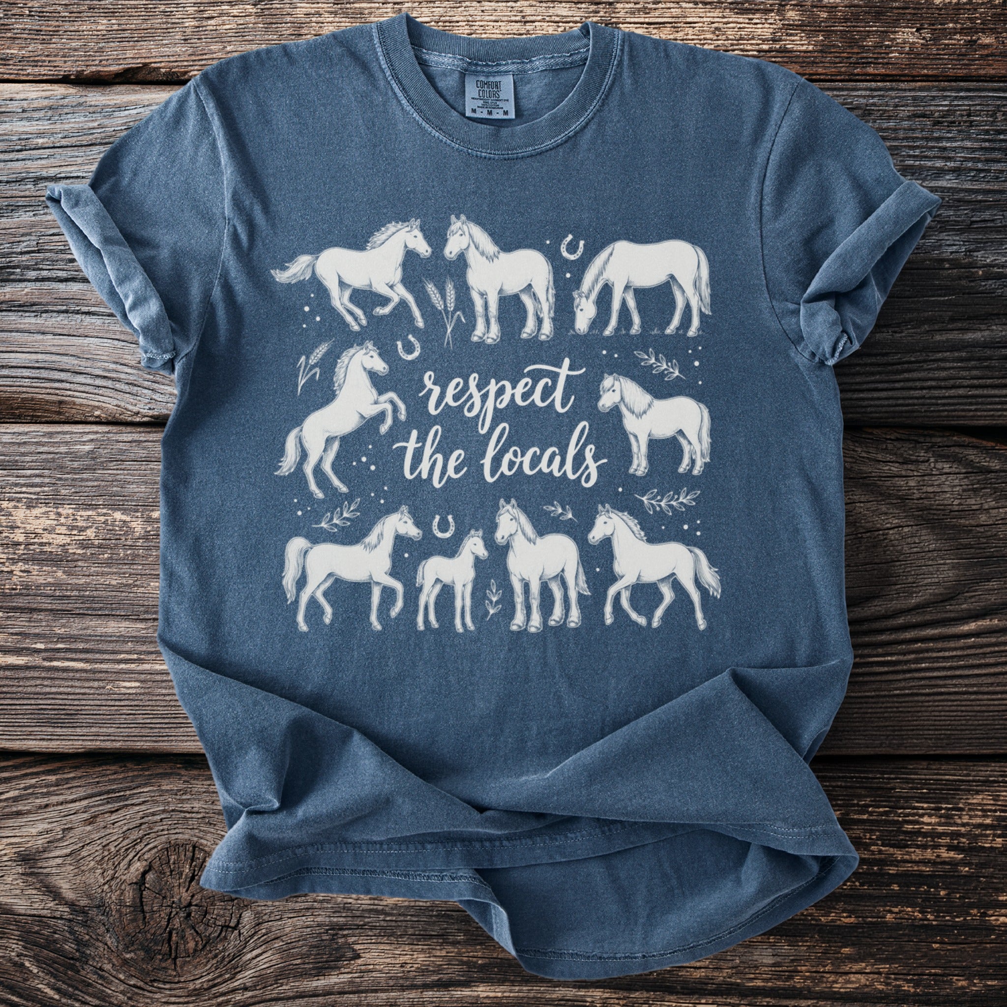 Blue t-shirt with white horse illustrations and "respect the locals" text.