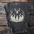 Dark gray t-shirt with four antlered robed figures seated around a fire beneath an arch of branches and a hanging deer skull.