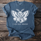 Blue t-shirt with a white moth graphic and text "i ate your sweater."