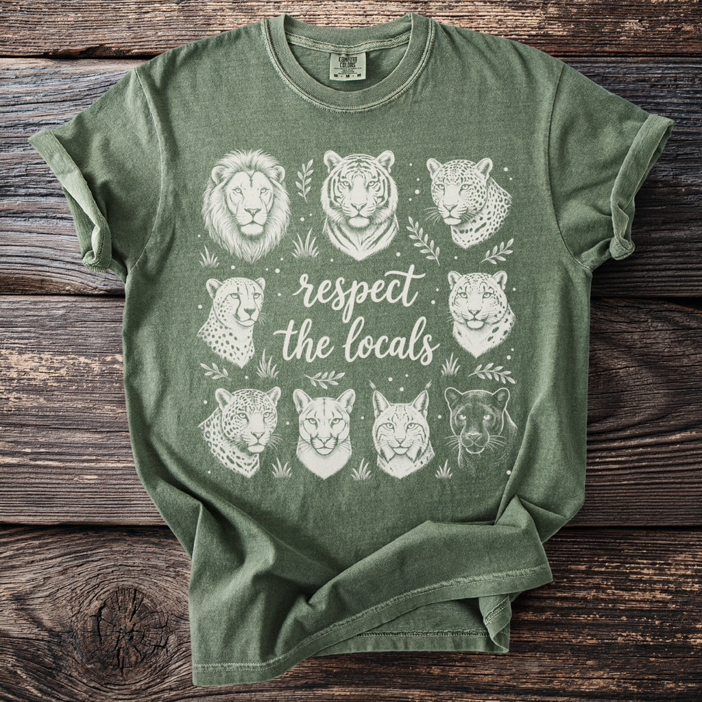 Green t-shirt with white illustrations of big cats and text "respect the locals."
