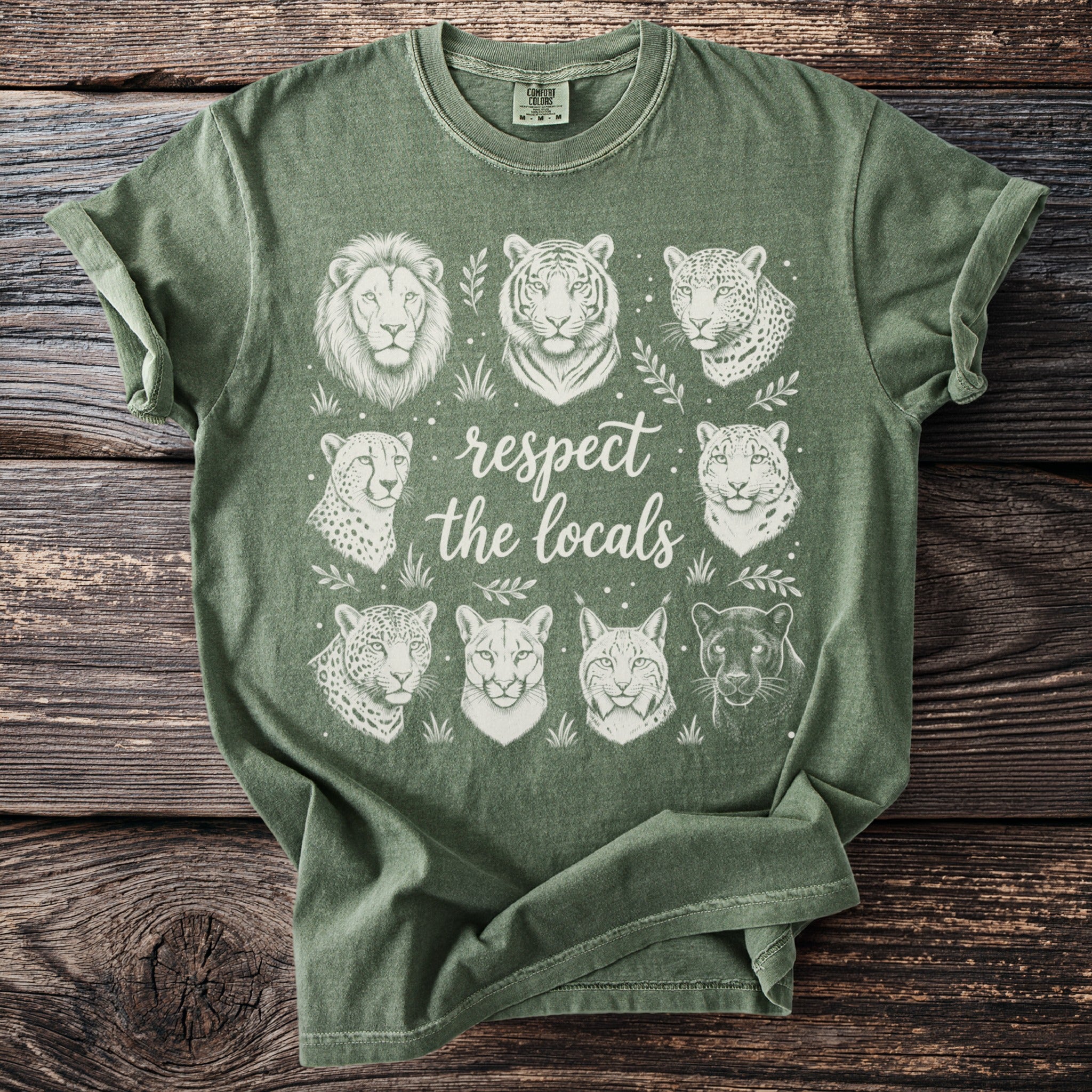Green t-shirt with white illustrations of big cats and text "respect the locals."